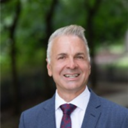 Bill Gaudelli dressed in a blue suit